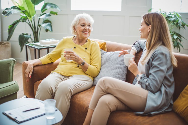Senior woman consulting with female advisor