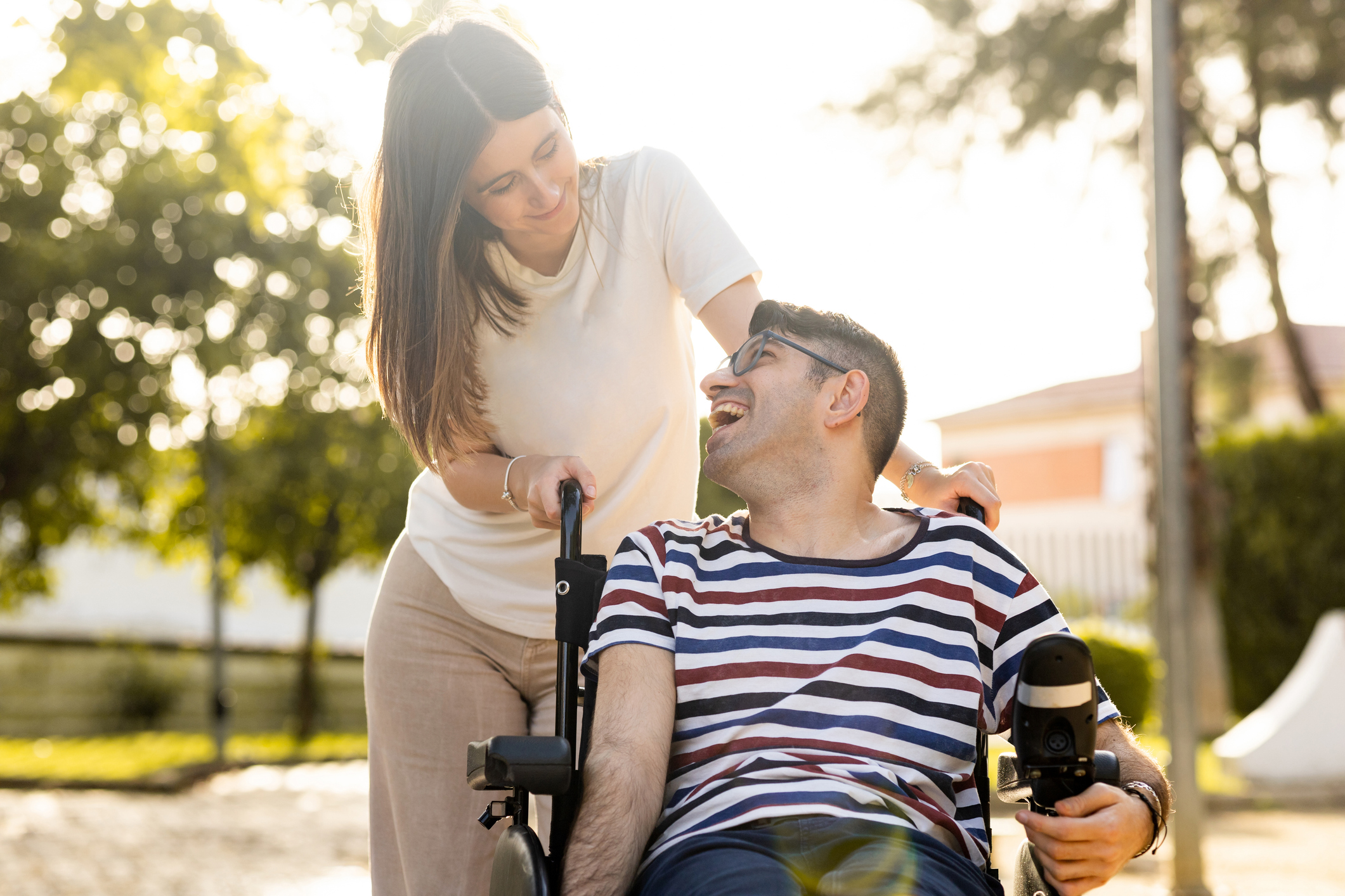 SYNERGY HomeCare caregiver pushing client in wheelchair