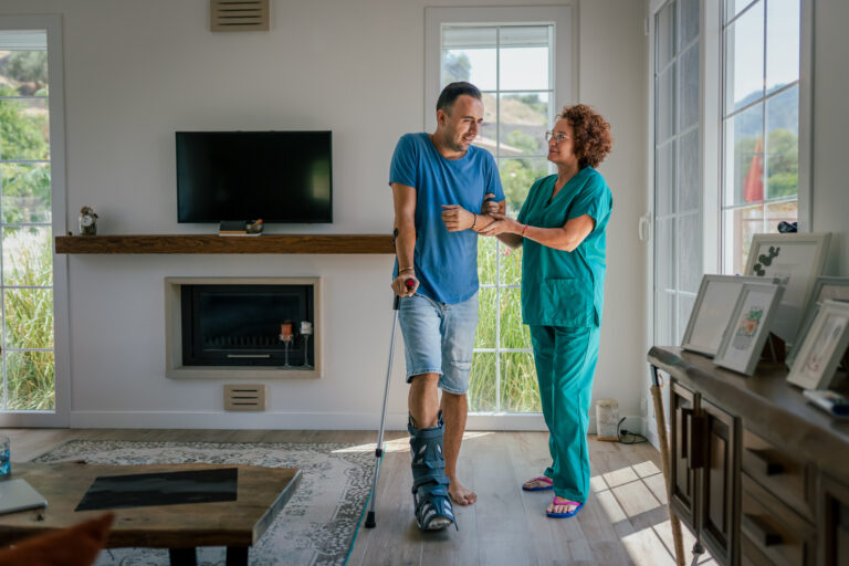 Nurse helping Young man with physical therapy in his home