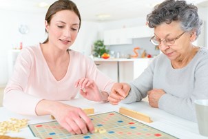 bigstock-elderly-woman-playing-a-board-85498088.jpg
