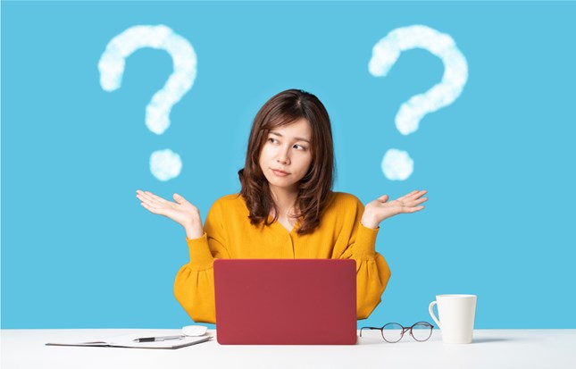 woman on laptop with questions
