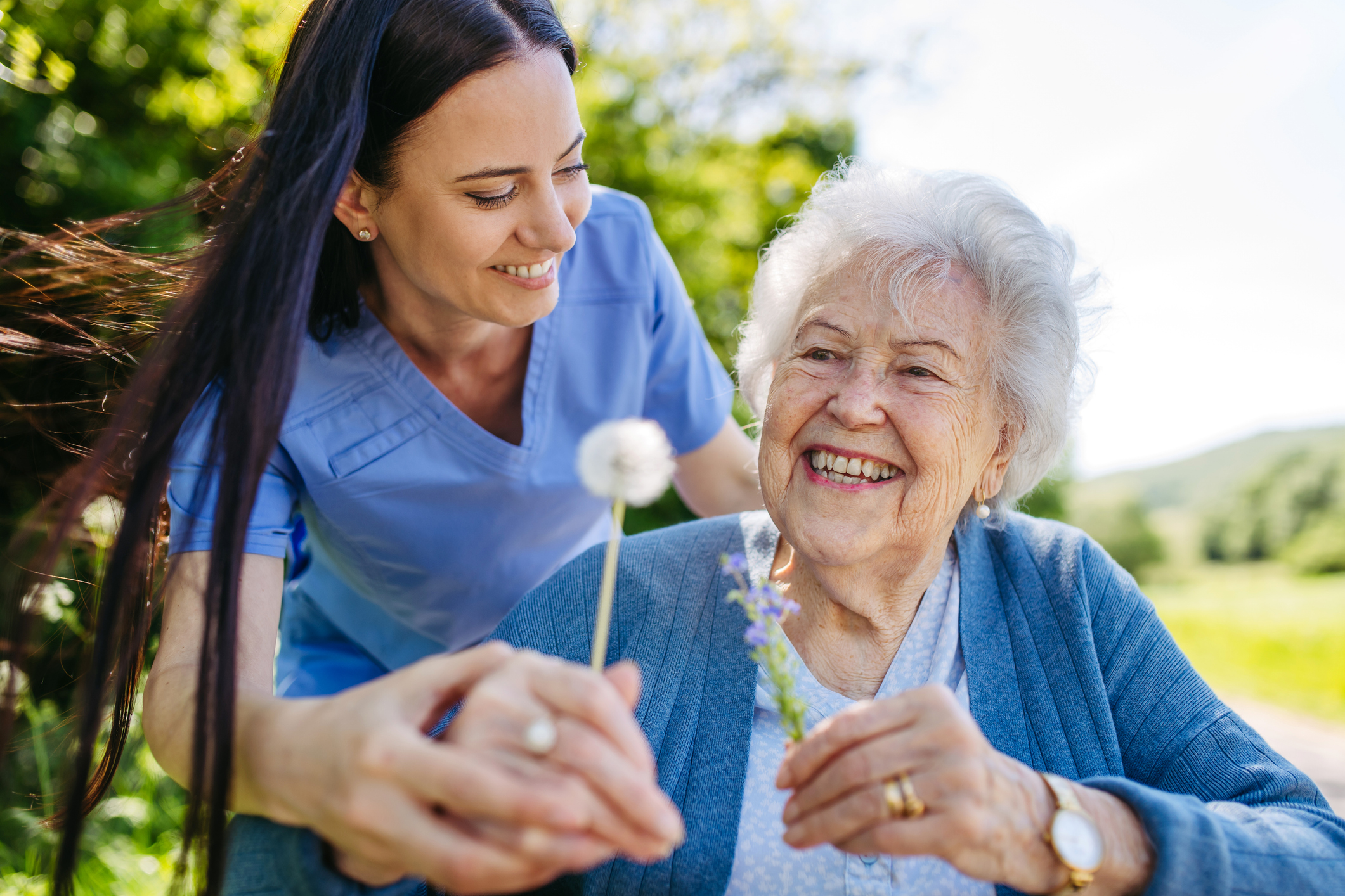 Caregiver and senior enjoying outside
