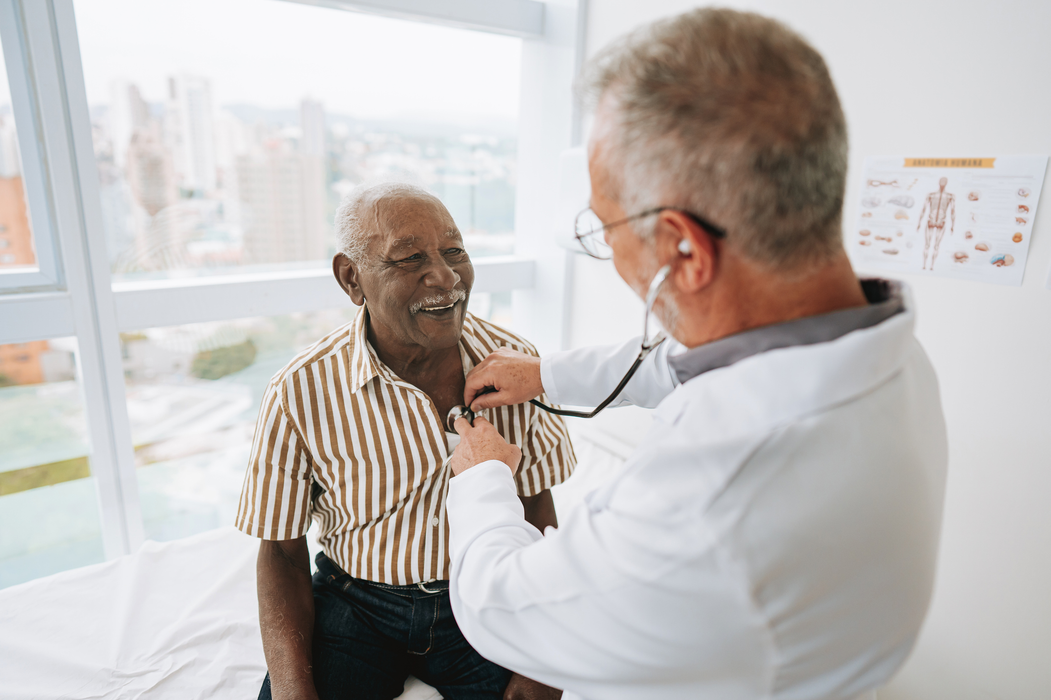 Doctor conducting a heart health checkup on a smiling senior patient