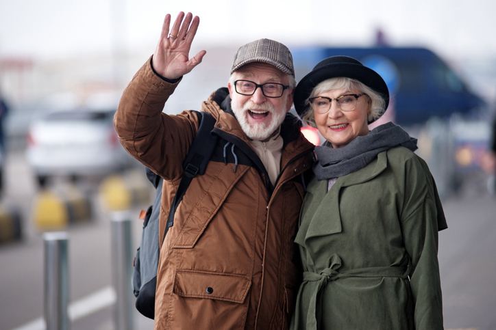 Two senior partners in stylish winter clothing smiling outdoors on a crisp day
